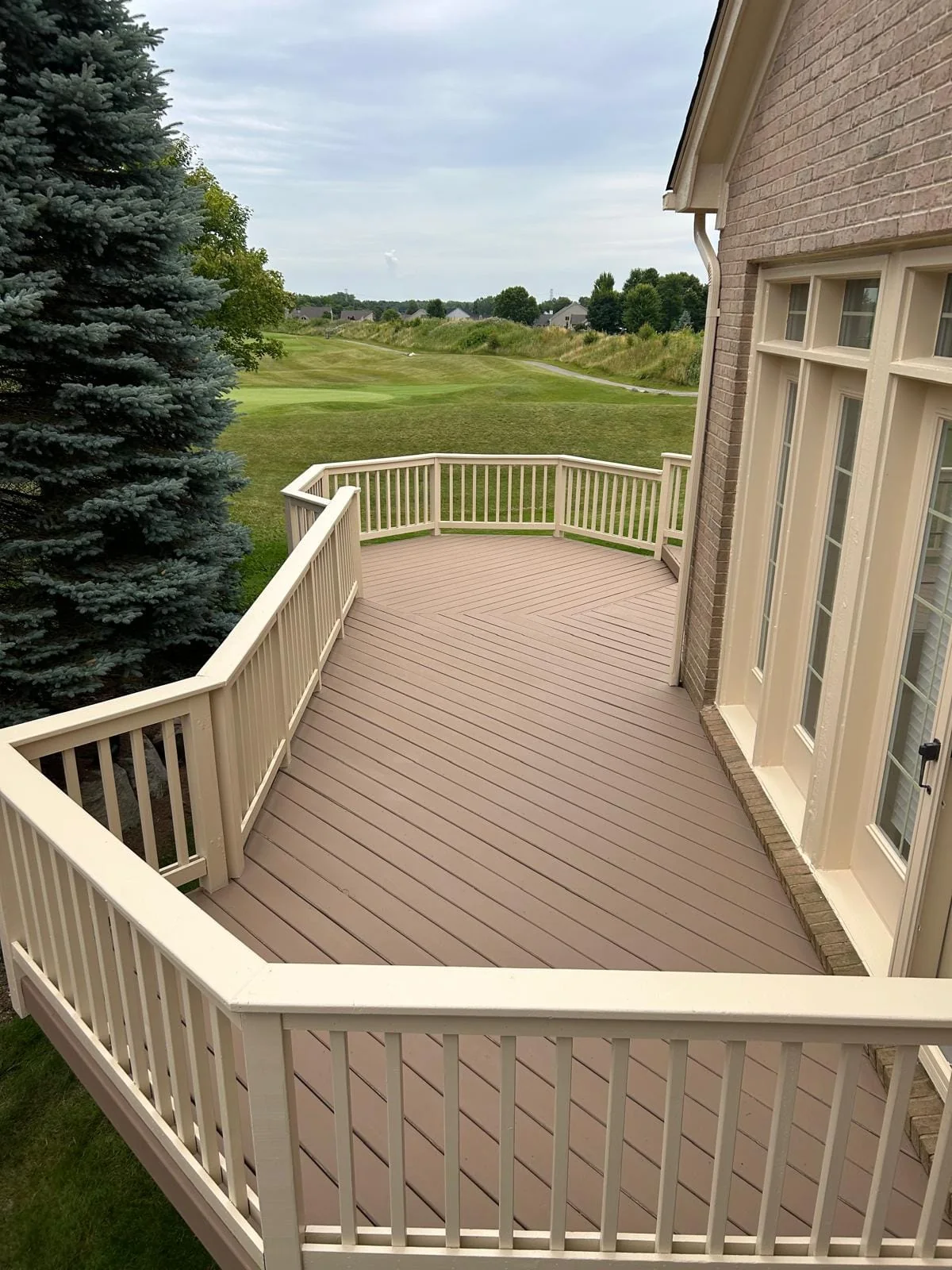 Deck with freshly painted brown boards and cream railings