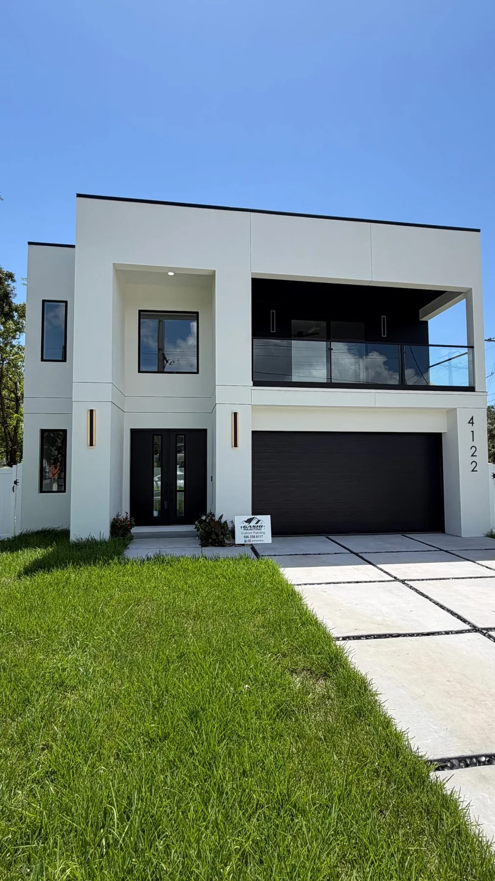 Modern white and black two-story home painted by Gashi Painting