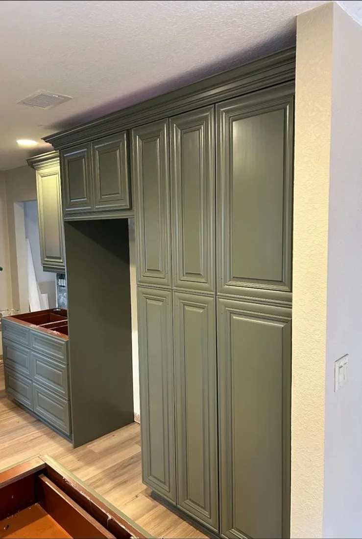 Olive green pantry cabinets with crown molding, freshly refinished