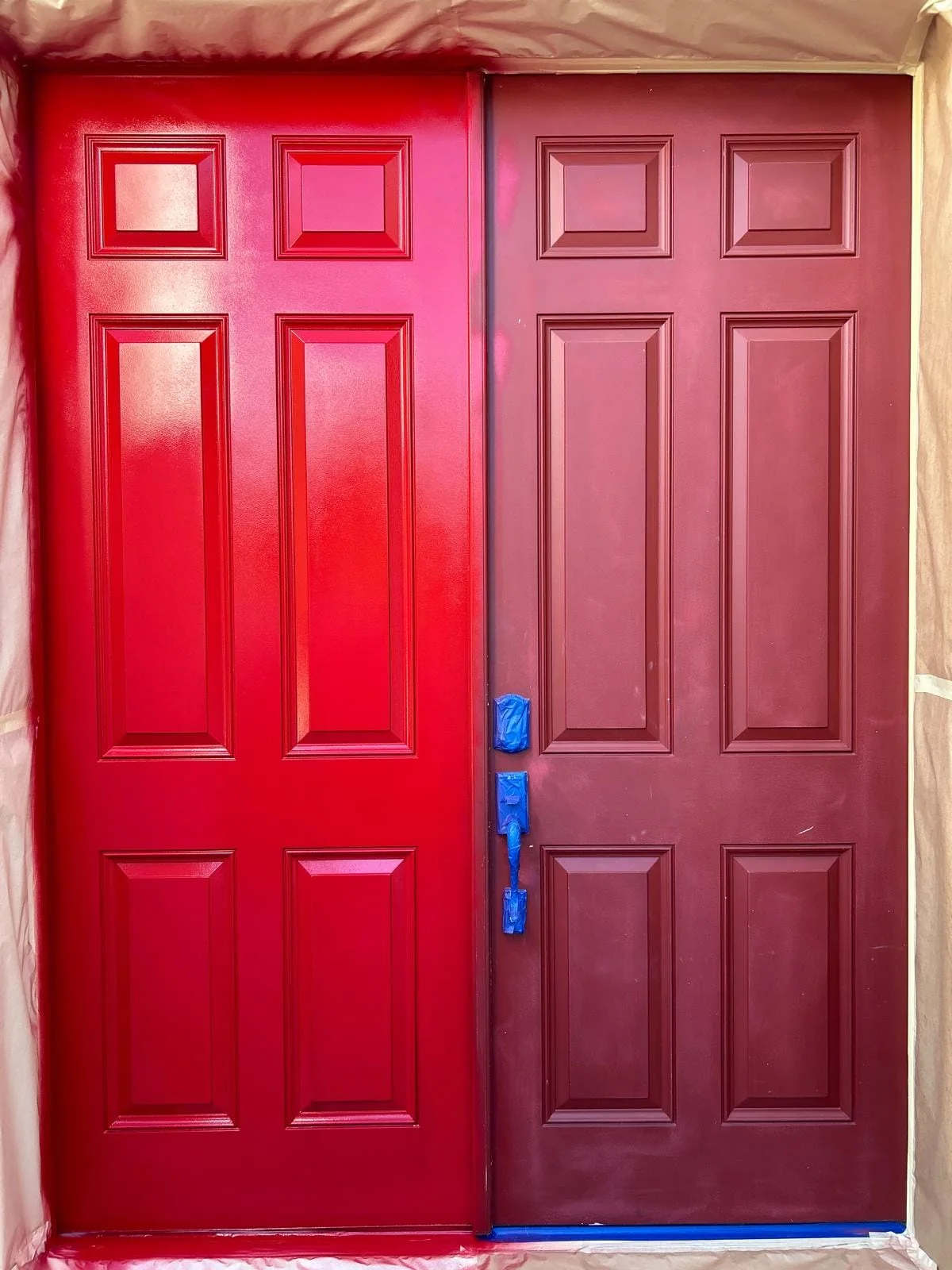 Front double door mid-repaint, glossy new red beside the faded original