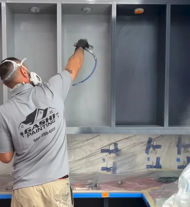 Spraying cabinets in a Gashi Painting shirt